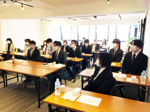 社長のスピーチを聞く従業員